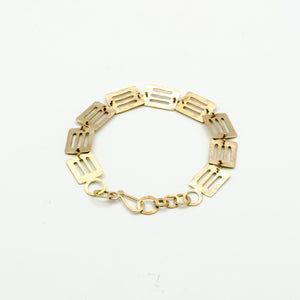 top view of cutout brass pieces bracelet on white background