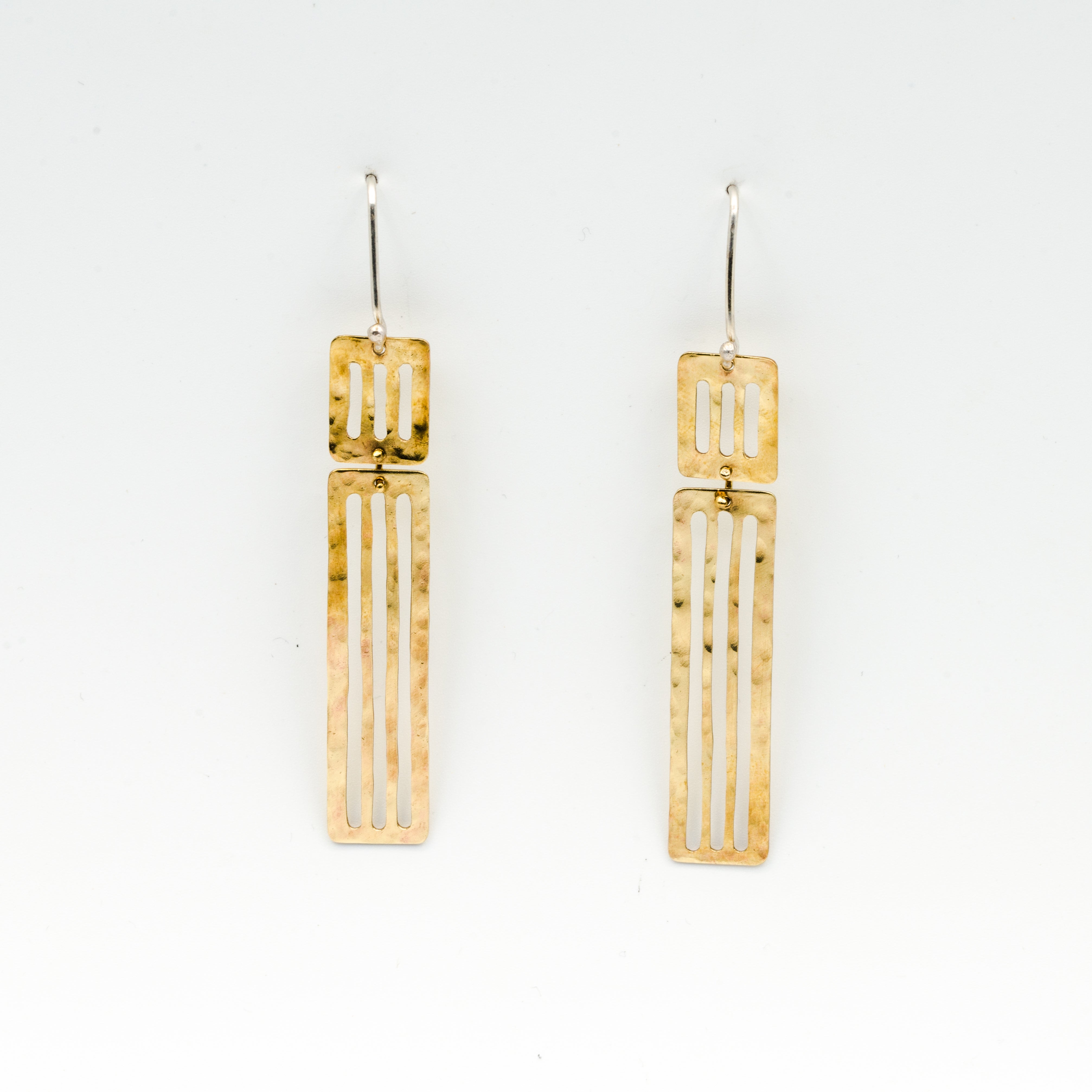 long dangly earrings hanging on white background
