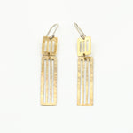 long dangly earrings laying flat on white background