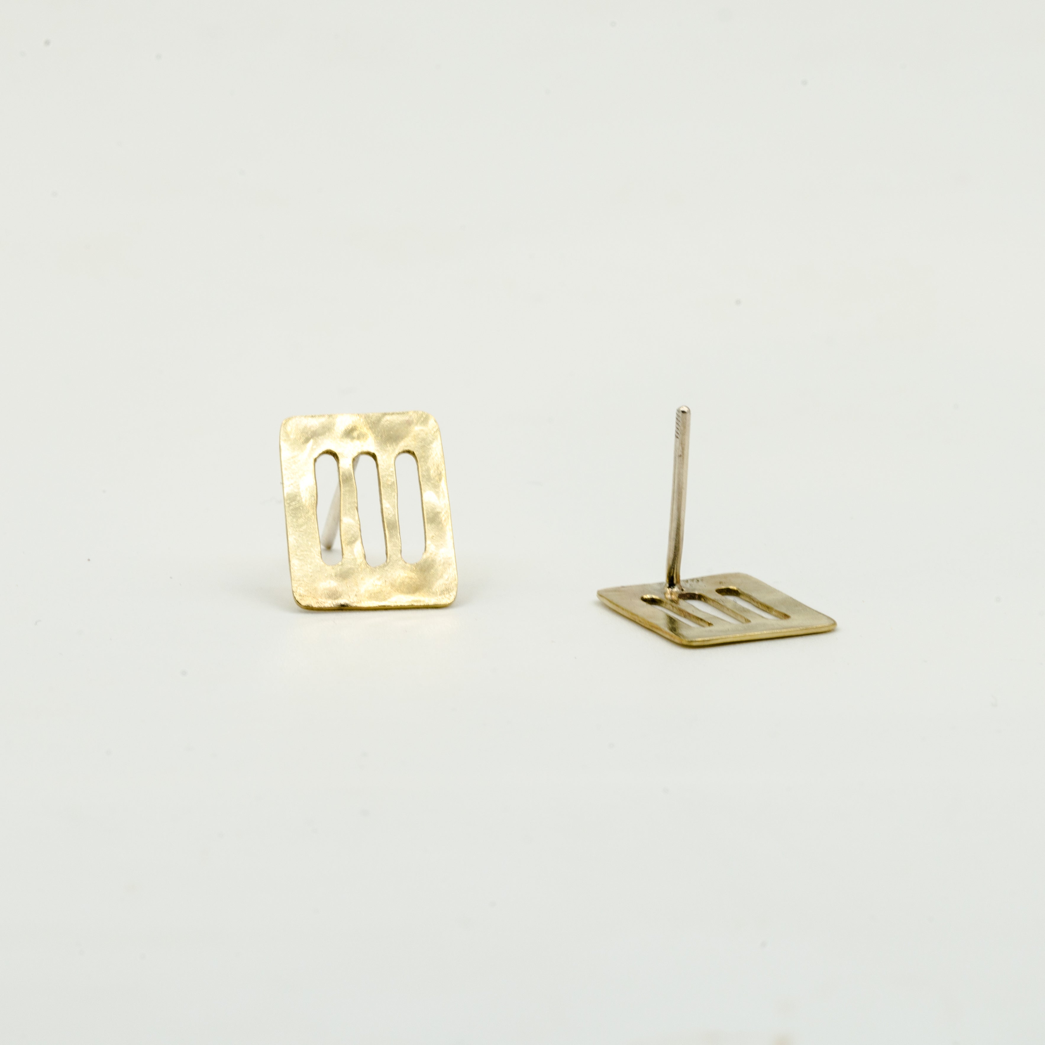 cutout brass sheet stud earrings on white background