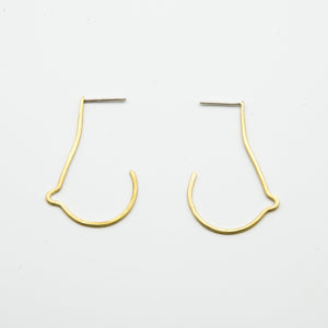 breast shaped brass wire earrings on white background
