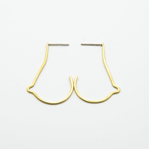 breast shaped brass wire earrings on white background close together